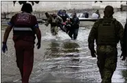  ?? AP PHOTO ?? Emergency teams help rush to safety injured civilian evacuees who had came under fire from Russian forces while trying to flee by boat from the Russian-occupied east bank of a flooded Dnieper River to Ukrainian-held Kherson, on the western bank in Kherson, Ukraine on Sunday, June 11, 2023.