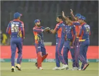  ?? — AFP ?? Karachi King’s Waqas Maqsood (C) celebrates the wicket of Quetta Gladiators’ Ahmad Shahzad during the Pakistan Super League (PSL) T20 match at the National Stadium in Karachi on March 15.