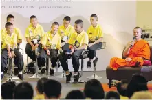  ?? GEMUNU AMARASINGH­E, THE ASSOCIATED PRESS ?? Ekapol Chantawong, right, former coach of the Wild Boars soccer team, speaks at one of Bangkok’s largest shopping malls about the team’s ordeal of being trapped for almost three weeks in a flooded cave.