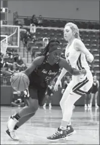  ?? The Sentinel-Record/Grace Brown ?? SUPER SOPHOMORES: Hot Springs guard Jaylia Reed, left, dribbles against Lake Hamilton’s Aspen Thornton Friday during the Lady Trojans’ 44-32 loss at Wolf Arena in Pearcy.