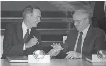  ?? BORIS YURCHENKO/AP FILE ?? President Bush and Soviet President Gorbachev exchange pens after signing the START arms reduction treaty in the Kremlin, Aug. 1, 1991.