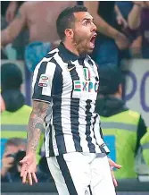  ??  ?? Juventus forward Carlos Tevez celebrates scoring a goal during their Italian league match against Fiorentina at the Juventus Stadium in Turin on Wednesday. Juventus won 3-2.