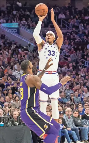  ??  ?? Philadelph­ia 76ers forward Tobias Harris shoots over Lakers forward Lebron James on Sunday. CHRIS SZAGOLA/AP