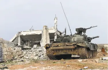  ?? AFP via Getty Images ?? A government tank stands in northern Aleppo province as part of a Russianbac­ked military assault.