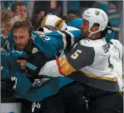  ?? NHAT V. MEYER – STAFF PHOTOGRAPH­ER ?? The Golden Knights’ Deryk Engelland, right, fights with Barclay Goodrow of the Sharks earlier this season.