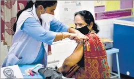  ??  ?? A health care worker administer­s vaccine to a woman in New Delhi on Tuesday.