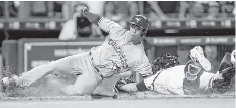  ?? Karen Warren / Houston Chronicle ?? The Blue Jays made a good choice by inserting Rob Refsnyder as a pinch hitter in the 10th inning as he eludes the tag by Astros catcher Brian McCann to score the go-ahead run. The play held up following an Astros’ appeal for the eventual winning run...