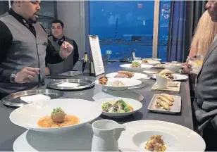  ?? PHOTOS BY ARLENE SATCHELL/STAFF ?? Staff members display sample dishes that will be served at the Flagship First Dining restaurant in America Airlines’ new Flagship Lounge at Miami Internatio­nal Airport.