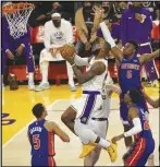  ?? ?? KEVIN REECE/Special to Valley Press Lakers forward LeBron James (center) goes up for a bucket while surrounded by Detroit Pistons defenders on Sunday at Staples Center. James scored 33 points in the Lakers’ 110-106 victory.