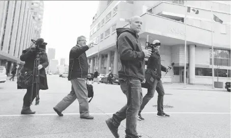  ?? POSTMEDIA ?? Pot advocate Leo Lucier walks to Windsor Police headquarte­rs Wednesday after his business, Compassion House, was raided Tuesday night.