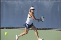  ??  ?? Jesse Muñoz/ COC Sports Informatio­n Director College of the Canyons tennis player Leilani Figalan sets her sights on the ball during the first women’s tennis match in school history Friday.