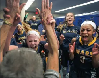  ??  ?? Mars’ Lauren Wasylson high-fives coach Dana Petruska after a 59-52 win against host Hampton Thursday. Mars and Hampton are co-section champions.Steph Chambers/Post-Gazette