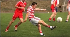  ??  ?? Ferns’ Thomas Hawkins sends the ball goalward during the IFC quarter-final clash in St Patrick’s Park.