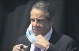  ?? MARK LENNIHAN — ASSOCIATED PRESS ?? New York Gov. Andrew Cuomo removes a mask as he holds a news conference in this file photo from Monday, June 15, 2020, in Tarrytown, N.Y.