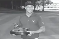  ??  ?? Bryson DeChambeau holds the trophy after winning the John Deere Classic golf tournament on Sunday in Silvis, Ill.