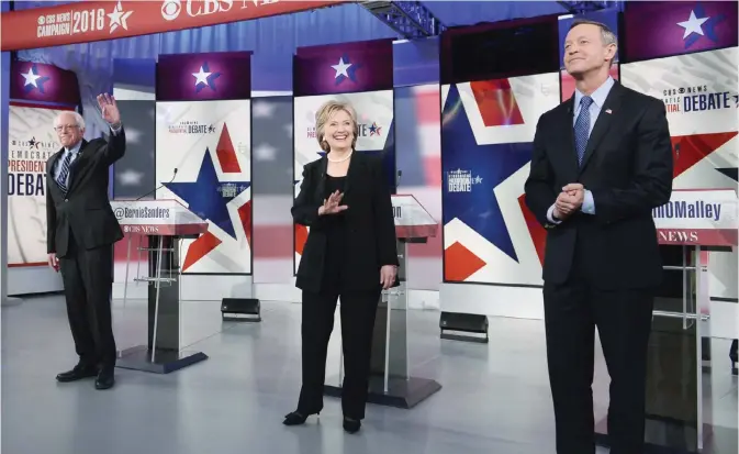  ?? AFP ?? DES MOINES, Iowa: Democratic Presidenti­al hopeful Hillary Clinton and Bernie Sanders (left) wave and Martin O’Malley looks on during the second Democratic presidenti­al primary debate in the Sheslow Auditorium of Drake University on Saturday.—