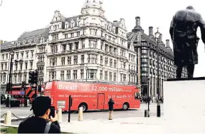  ?? AP ?? A bus drives past the Houses of Parliament in London on February 21, 2018. Some British ministers are concerned that the offshore regimes of the UK’s overseas territorie­s are facilitati­ng criminalit­y, money laundering, and terrorism.