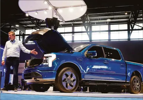  ?? Antonio Perez / Tribune News Service ?? The highly anticipate­d Ford F-150 Lightning at McCormick Place in Chicago in 2021. Ford has told its dealers they have until Friday to decide whether to invest between $500,000 and $1.2 million to continue selling the company's electric vehicles beyond 2023.