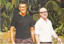  ?? AP-Yonhap ?? Italian fashion designers Stefano Gabbana, left, and Domenico Dolce take the catwalk after presenting their Dolce & Gabbana men’s fashion collection in Milan, Italy, in this 2012 file photo.