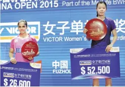  ??  ?? FUZHOU: Li Xuerui (R) of China and Saina Nehwal of India pose with their trophies after their women’s singles final match at the China Open badminton tournament in Fuzhou, east China’s Fujian province yesterday. — AFP