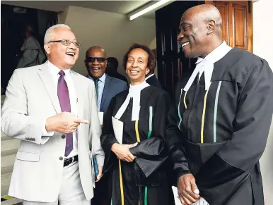  ?? FILE ?? Justice Minister Delroy Chuck (left) tickles the funny bone of Justice Carol Lawrence-Beswick and acting Chief Justice Bryan Sykes at the official opening of Parliament and tabling of the Estimates of Expenditur­e for 2018-2019 at Gordon House last...