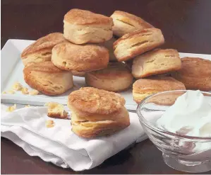  ??  ?? Baking the biscuits in a heavy cast-iron skillet gives them a crisp crust with a tender interior.