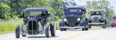  ?? MICHAEL GARD/POST-TRIBUNE PHOTOS ?? Vintage vehicles make their way north on State Road 55 during the running of the Cobe Cup on Saturday.