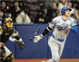  ?? LEE JIN-MAN / ASSOCIATED PRESS ?? Los Angeles Dodgers designated hitter Shohei Ohtani (right) heads to first as he grounds out while San Diego Padres catcher Luis Campusano watches during the seventh inning of an opening day baseball game at the Gocheok Sky Dome in Seoul, South Korea Wednesday in Seoul, South Korea.