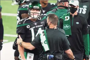  ?? John Minchillo / Associated Press ?? Trainers check on Jets quarterbac­k Sam Darnold during the first half of a loss to the Broncos on Thursday.