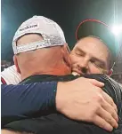  ?? BRYNN ANDERSON/ASSOCIATED PRESS ?? Atlanta’s Freddie Freeman embraces manager Brian Snikter after the Braves beat the Brewers 5-4 in Game 4 of their NL Division Series on Tuesday in Atlanta.