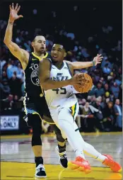  ?? DOUG DURAN — BAY AREA NEWS GROUP, FILE ?? Warriors guard Stephen Curry (30) guards Jazz guard Donovan Mitchell (45) in the fourth quarter of their February 2019 game in Oakland.