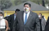  ?? ABEL URIBE/CHICAGO TRIBUNE ?? Gov. J.B. Pritzker arrives at a coronaviru­s testing site last week at Coles Elementary School in Chicago.