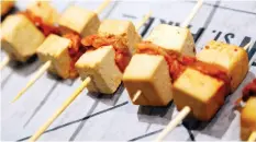  ??  ?? Kimchee tofu skewers, above, and avocado brownie cakepops, below, are two of the many delicacies found at the Queen St. Fare food hall. The culinary initiative takes its inspiratio­n from high-end multi-vendor spaces in New York and other cities.