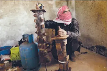  ?? Photograph­s by Frederic Lafargue Afp/getty Images ?? A SYRIAN REBEL assembles homemade bombs in Idlib province, where the recent military campaign has left insurgents increasing­ly desperate. They may soon resort to suicide bombings, one rebel said.