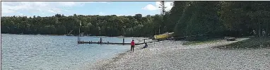  ?? Chicago Tribune/TNS/KURT CHANDLER ?? Countless limestone face a stiff fine. rocks line Schoolhous­e Beach along the waters of Washington Harbor. Visitors caught removing the rocks