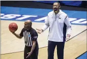  ?? ROBERT FRANKLIN — THE ASSOCIATED PRESS ?? Michigan head coach Juwan Howard questions a call during the second half of a first-round game against Texas Southern in the NCAA Tournament on Saturday at Mackey Arena in West Lafayette, Ind.