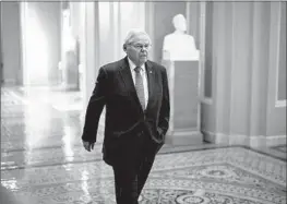  ?? Andrew Harnik Getty Images ?? SEN. ROBERT Menendez (D-N.J.) walks toward the Senate Chamber in April. Menendez has been accused of accepting bribes to perform a variety of favors.