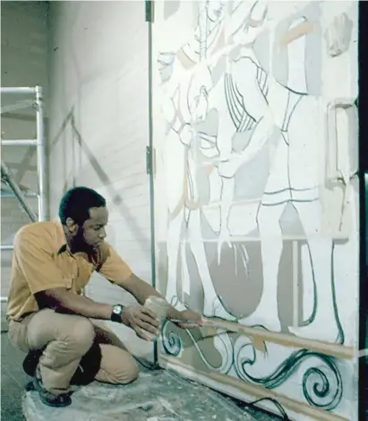  ?? CHICAGO DEPARTMENT OF CULTURAL AFFAIRS AND SPECIAL EVENTS ?? Eugene “Eda” Wade works on the doors at Malcolm X College to transform them into works of art spotlighti­ng Black culture and Egyptian and West African designs. The early 1970s project took two years.