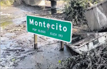  ?? Mike Eliason ?? Santa Barbara County Fire Department The U.S. 101 freeway remains underwater Monday as cleanup crews work to clear the roads throughout Montecito, Calif.