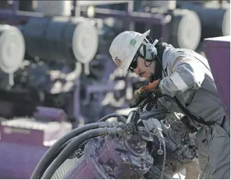  ?? BRENNAN LINSLEY/AP ?? A worker oils a pump during a hydraulic fracturing operation near Mead, Colo. GMP FirstEnerg­y analyst Martin King expects oil prices to rise despite concerns about the surging U.S. shale output.
