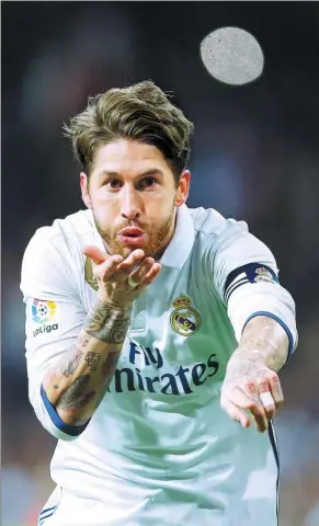  ?? FRANCISCO SECO / AP ?? Real Madrid’s Sergio Ramos blows a kiss after scoring the winner in Sunday’s 2-1 La Liga victory over Real Betis at Santiago Bernabeu stadium in Madrid.