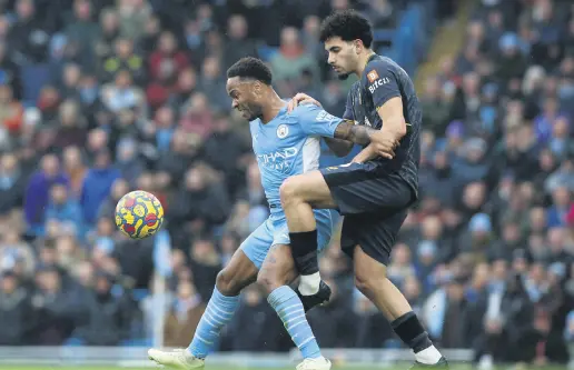  ?? ?? Man City’s Raheem Sterling (L) vies with Wolves&#039; Rayan Ait-Nouri during a Premier League match at the Etihad Stadium, Manchester, England, Dec. 11, 2021.