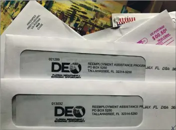  ?? WILFREDO LEE — THE ASSOCIATED PRESS ?? Envelopes from the FloridA DepArtment of EConomiC Opportunit­y Reemployme­nt AssistAnCe ProgrAm Are shown Nov. 5 in Surfside, FlA.