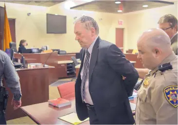  ?? EDDIE MOORE/JOURNAL ?? Ex-teacher Gary Gregor is escorted from a Santa Fe courtroom Wednesday after he was convicted on charges alleging abuse of fourth-grade girls when he was teaching at an Española elementary school a decade ago.