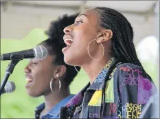  ??  ?? Halifax area singers Amariah Bernard Washington (left) and Zamani Bernard Millar sing a duet during the Journey Back to Birchtown celebratio­n on the July 14 weekend.