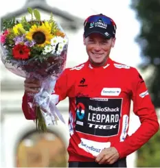  ?? AGENCE FRANCE PRESSE ?? RadioShack's US rider Chris Horner celebrates on the podium after winning the "Vuelta" Tour of Spain in Madrid on September 15, 2013. Chris Horner became the oldest ever winner of a cycling grand tour as the 41-year-old rubber stamped his victory in...