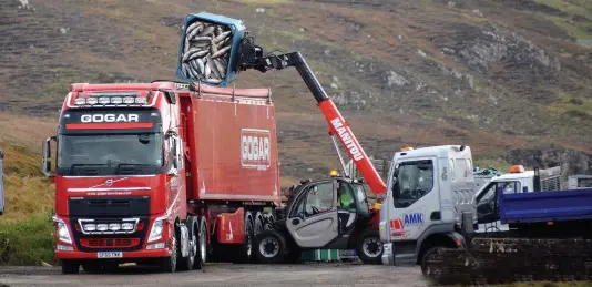  ??  ?? Waste: Tons of salmon are dumped into a lorry at Loch Erisort on Lewis to be transporte­d hundred of miles for incinerati­on