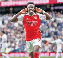  ?? ?? Hitman: Bukayo Saka celebrates scoring his goal for Arsenal (right, above); Tottenham’s Son Heung-min scores from the penalty spot to make it a nervy finish for the league leaders (below, right)