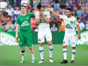  ?? MANU FERNANDEZ / AP ?? From left: Chapecoens­e plane crash survivors Jakson Follmann, Nieto and Alan Ruschel get emotional prior to their friendly against Barcelona at Camp Nou on Monday.