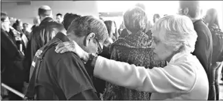  ??  ?? Prayer team members Richard Schick and Margaret Gillett pray during Break Forth on
Sunday